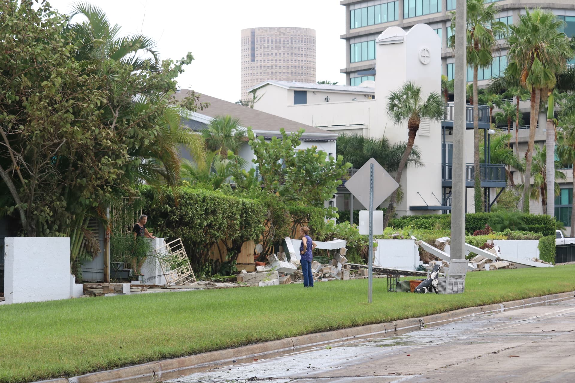 A women looking at wall destruction on Bayshore Blvd.