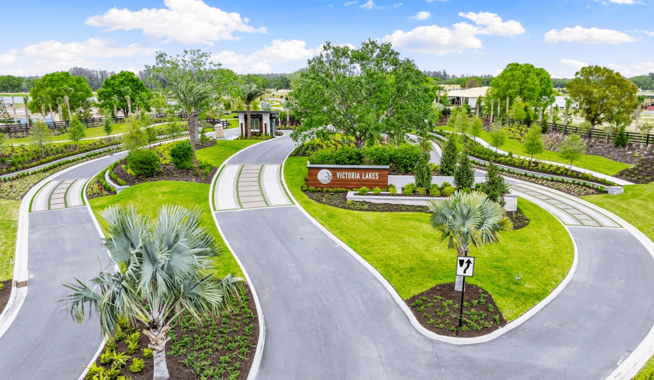 Rendering of the front of Victoria Lake. Lots of green grass and trees and freshly paved roads