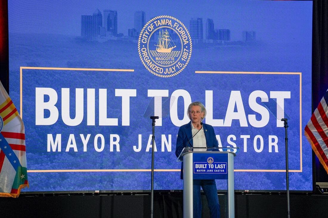 Mayor Jane Castor at a podium in front of a large blue screen that says built to last