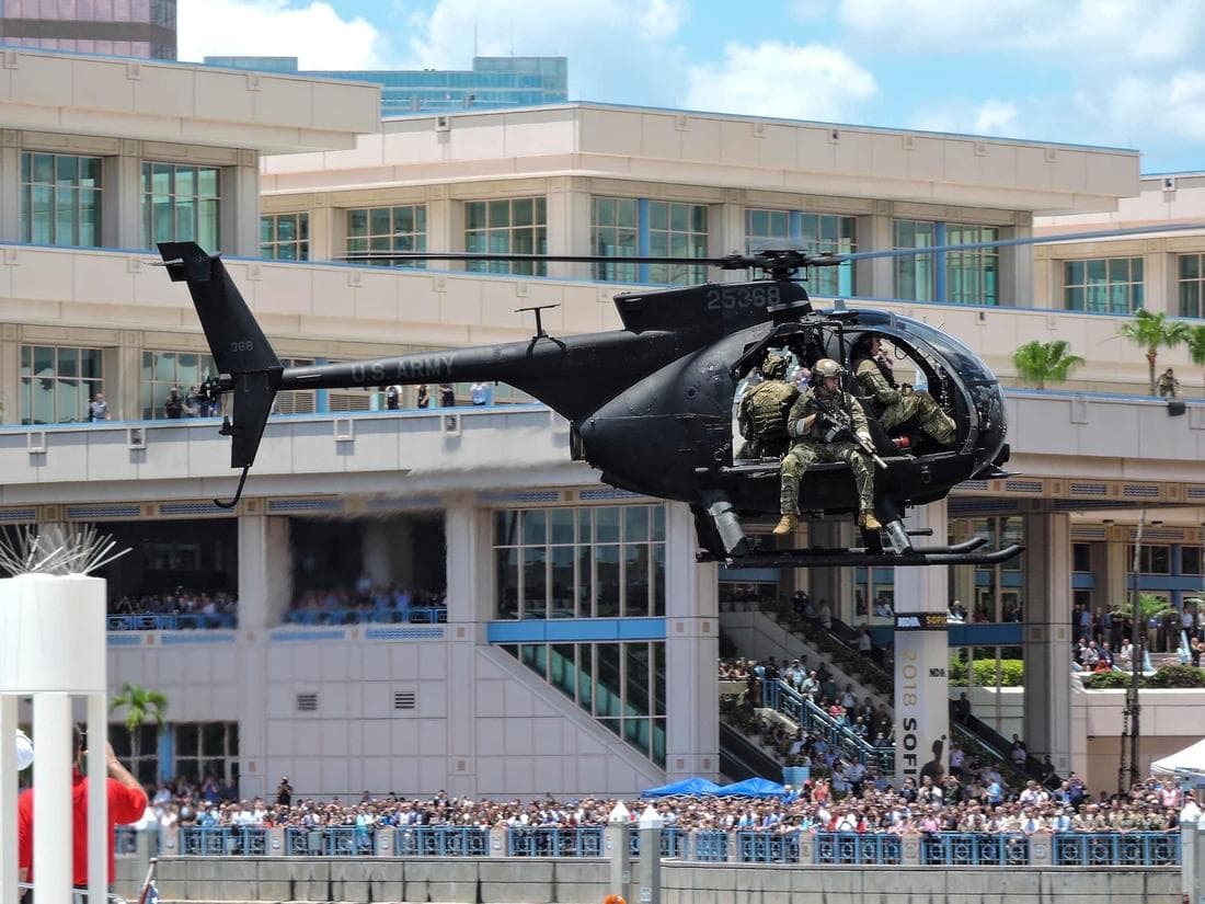 Black helicopter with military men sitting in it