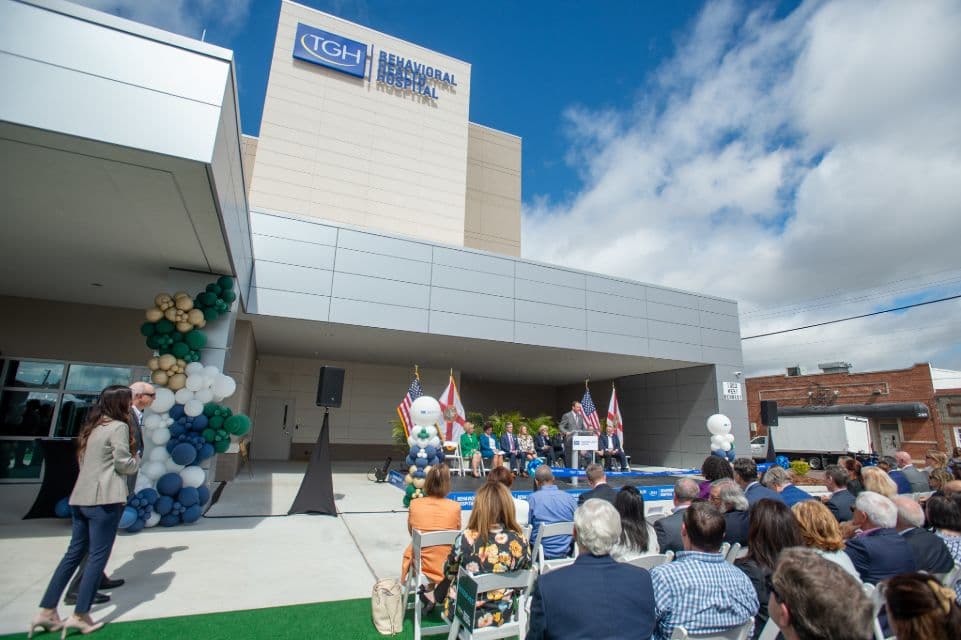 People sitting outside TGH Behavioral Health Hospital