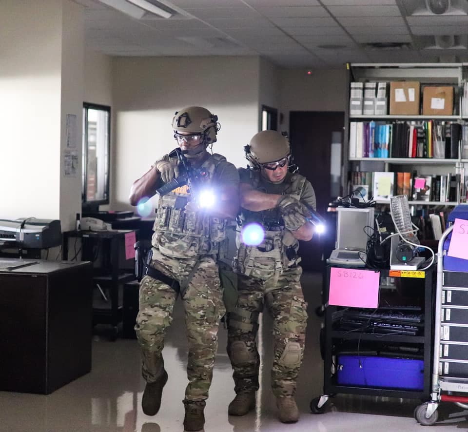 two officers with guns in a school