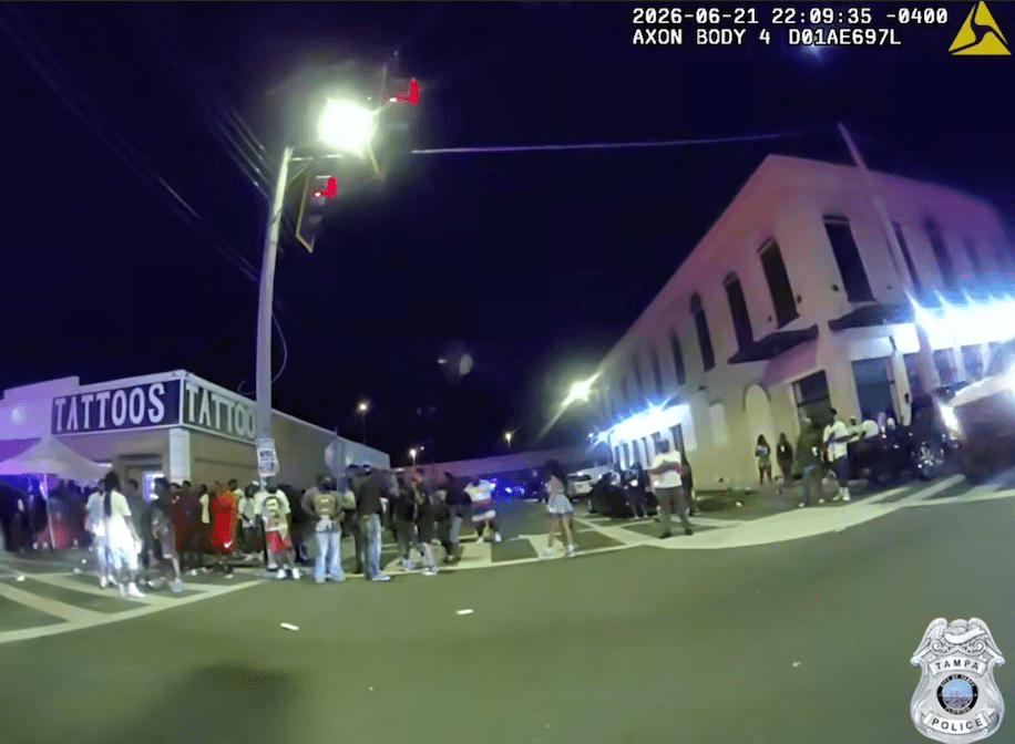 People on the street outside of a tattoo place in West Tampa