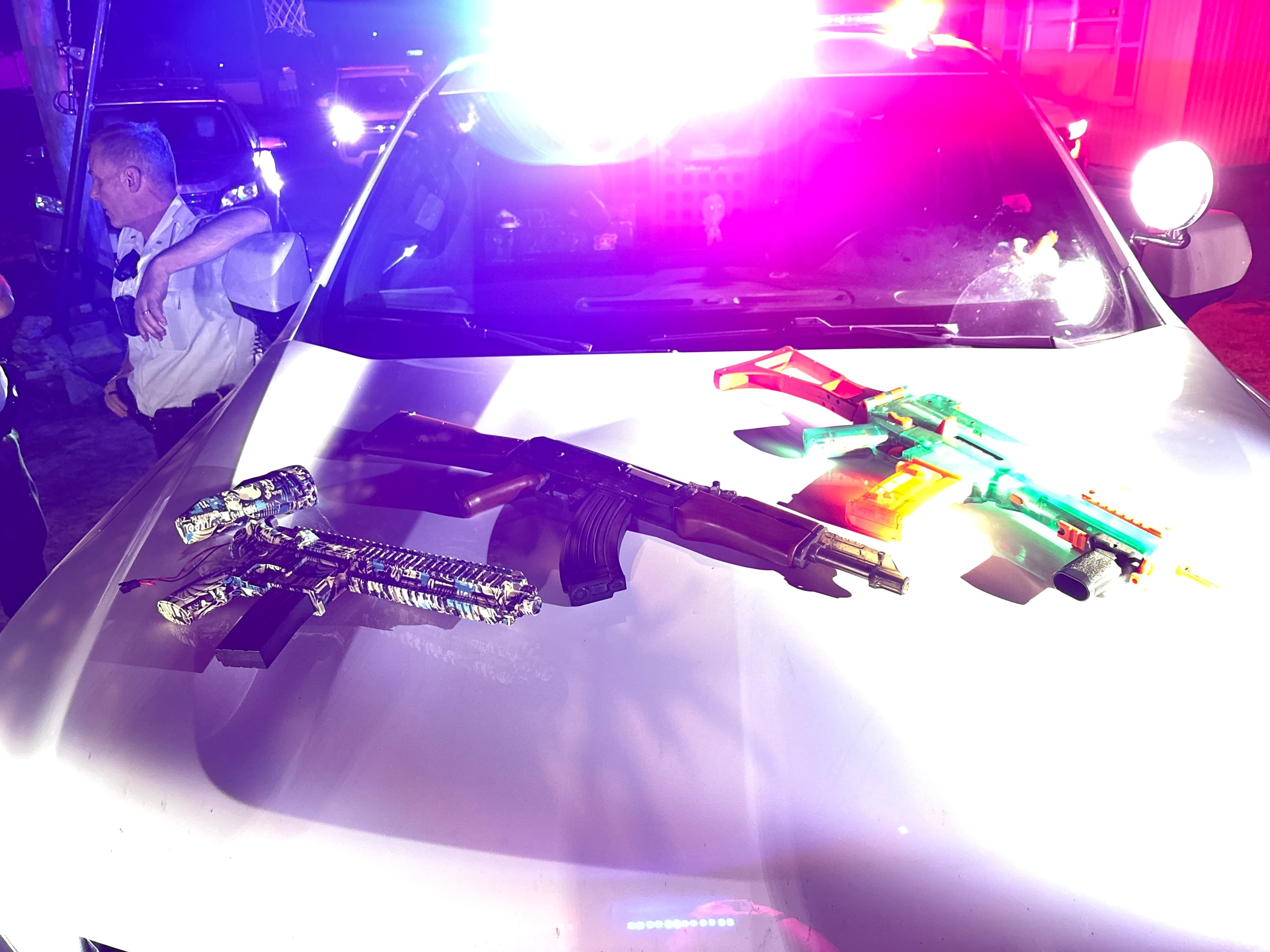 Three BB guns on a cop car