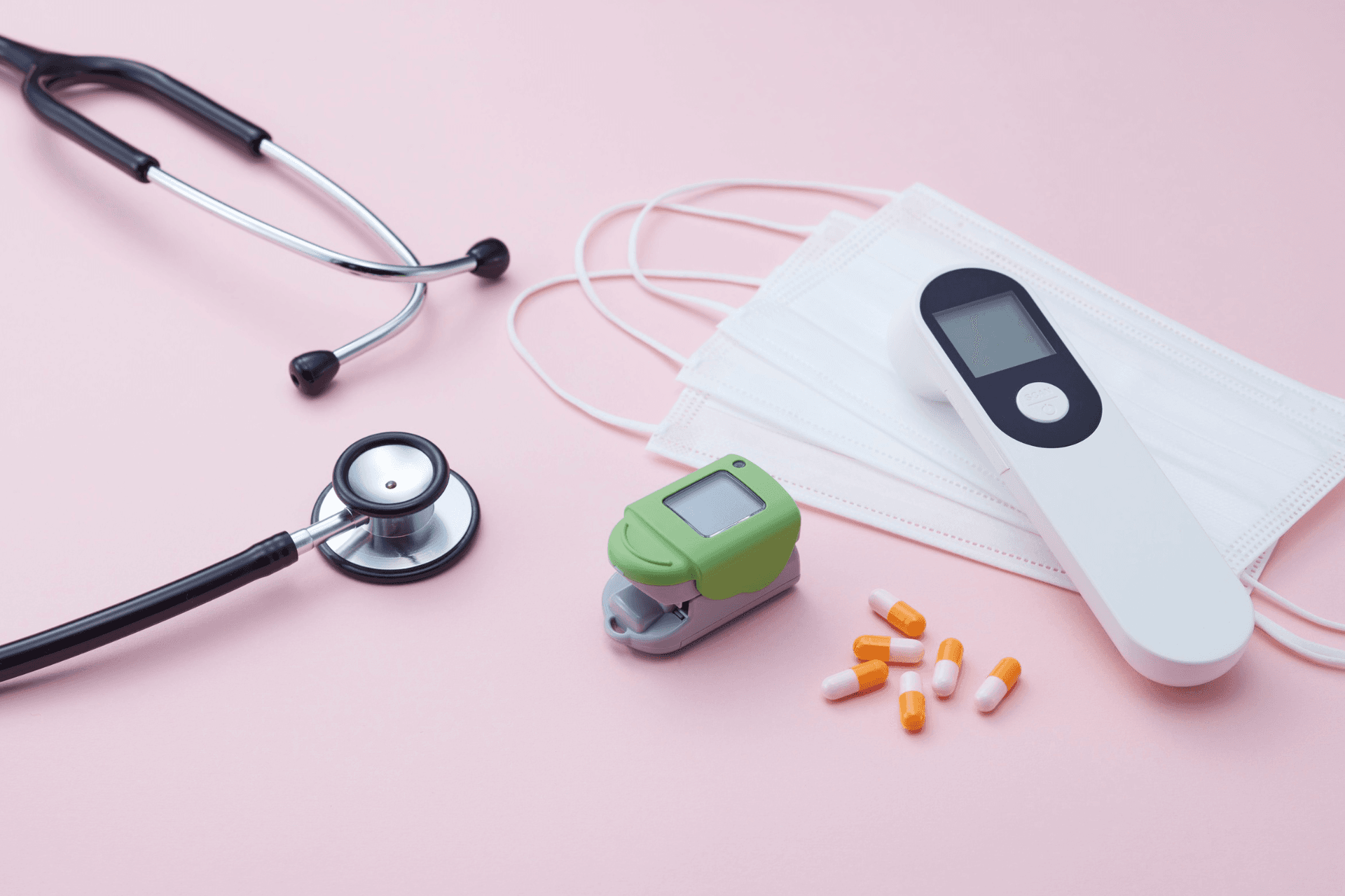 pink background with health supplies infront