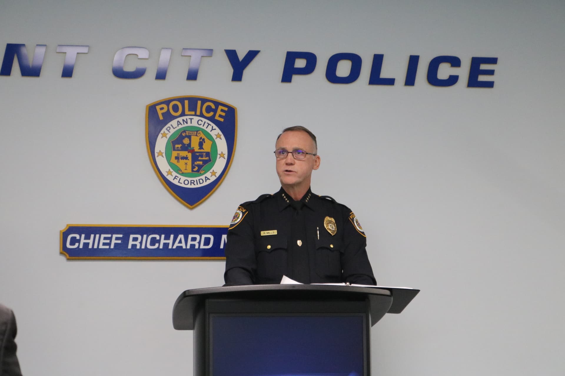 Cheif Mills speaking at a podium