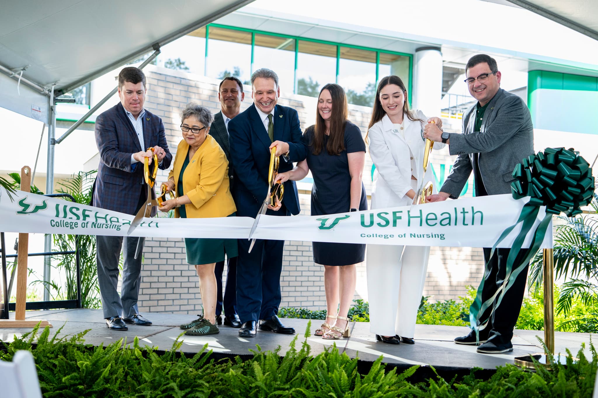 seven people cutting USF Health ribbon