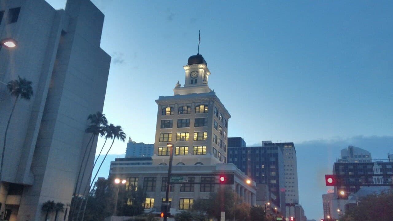 Tampa's Old City Hall clock tower lit at dusk on Kennedy Boulevard