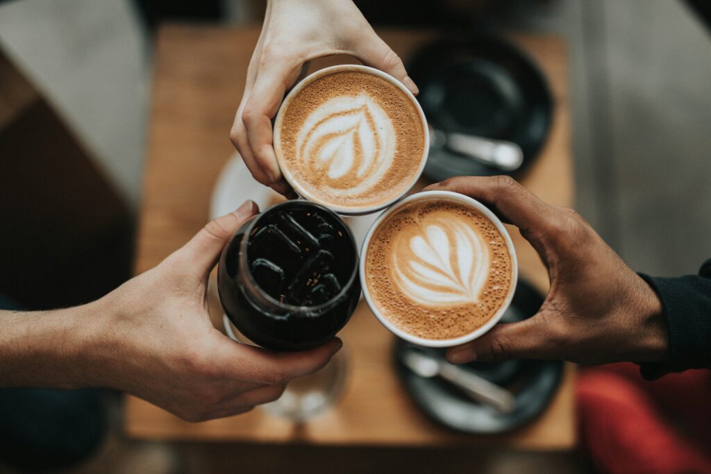 People Holding Coffee Drinks